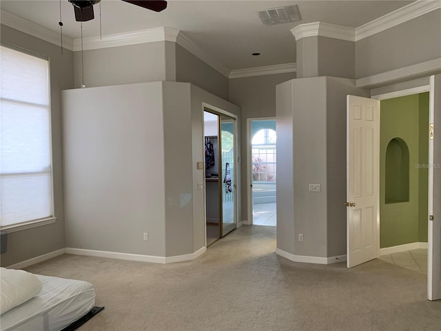 unfurnished bedroom featuring ceiling fan, light carpet, and ornamental molding