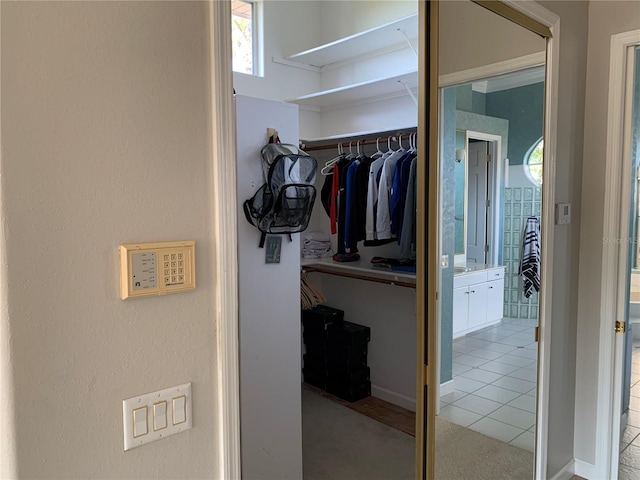 spacious closet with light tile patterned flooring