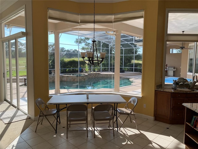 dining room featuring a notable chandelier and light tile patterned flooring