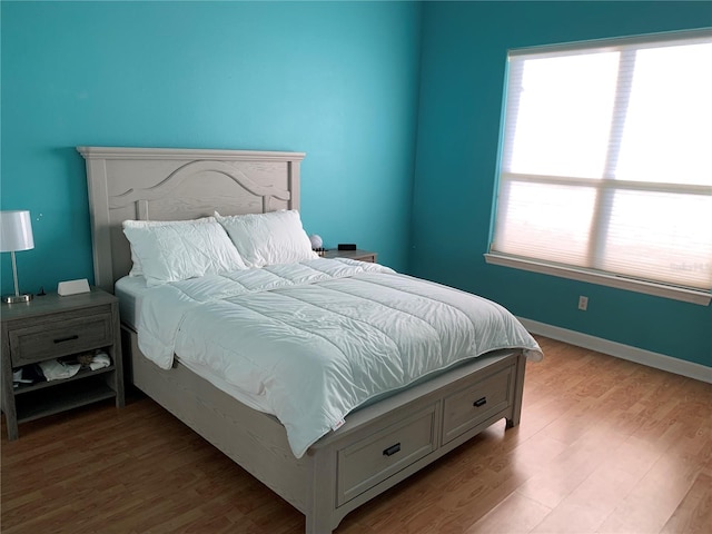 bedroom with hardwood / wood-style flooring