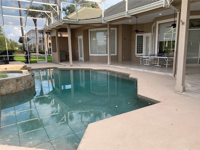 view of swimming pool with ceiling fan, an in ground hot tub, a patio area, and a lanai