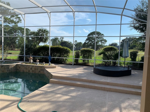 view of pool with a patio area and a lanai