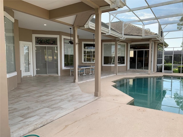 view of pool featuring glass enclosure and a patio