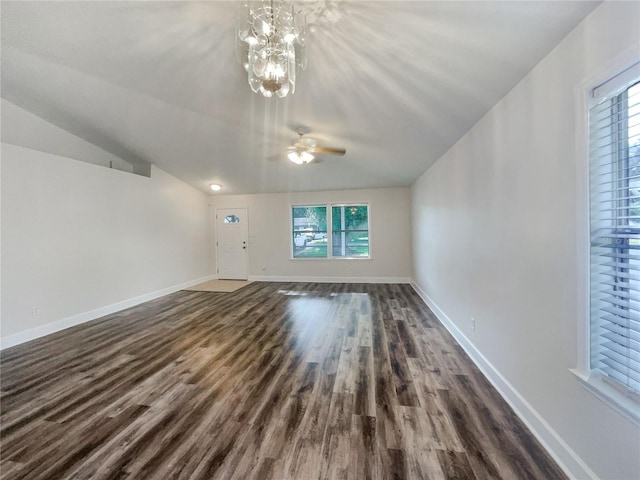 additional living space featuring ceiling fan with notable chandelier, dark hardwood / wood-style flooring, and lofted ceiling