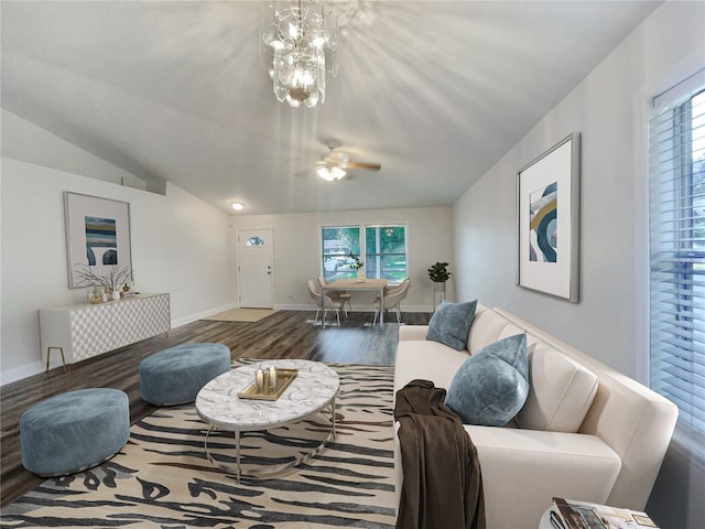 living room featuring lofted ceiling, a chandelier, and wood-type flooring