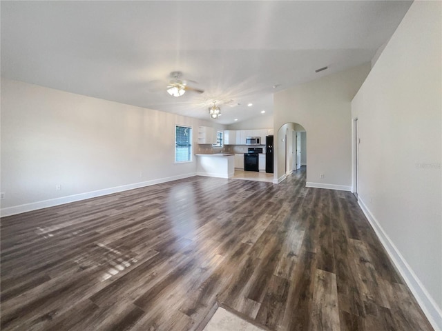 unfurnished living room with ceiling fan, vaulted ceiling, and hardwood / wood-style flooring