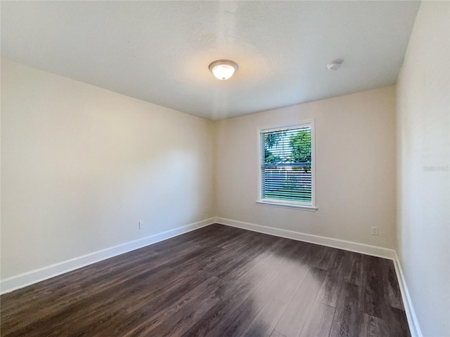 spare room featuring dark hardwood / wood-style flooring