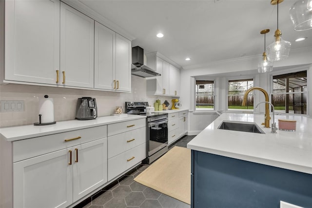 kitchen featuring a sink, light countertops, stainless steel electric range, decorative backsplash, and wall chimney exhaust hood