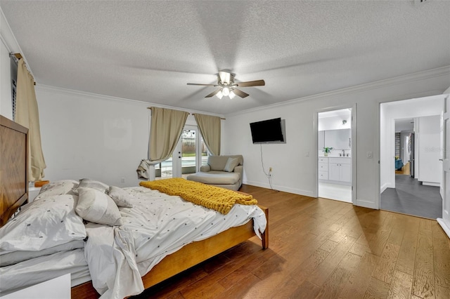 bedroom featuring baseboards, a ceiling fan, hardwood / wood-style flooring, ornamental molding, and a textured ceiling