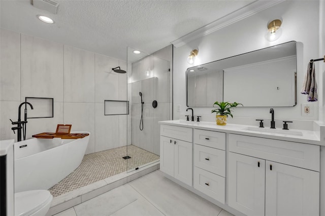 full bathroom featuring a walk in shower, a textured ceiling, a sink, visible vents, and double vanity