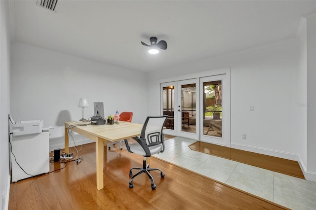 office space with baseboards, visible vents, wood finished floors, and french doors