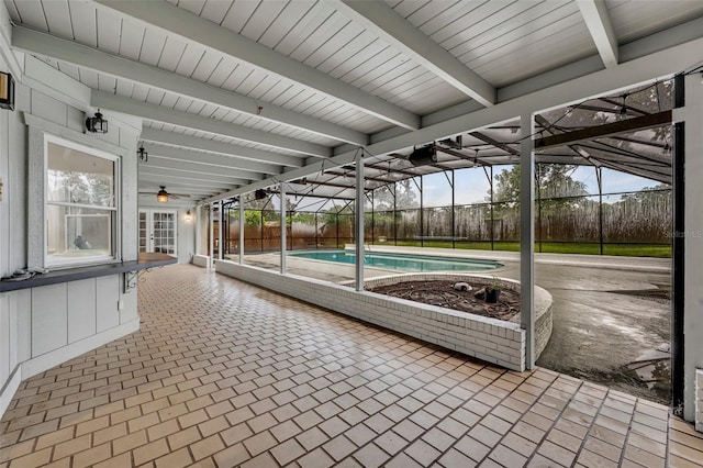 unfurnished sunroom with beam ceiling