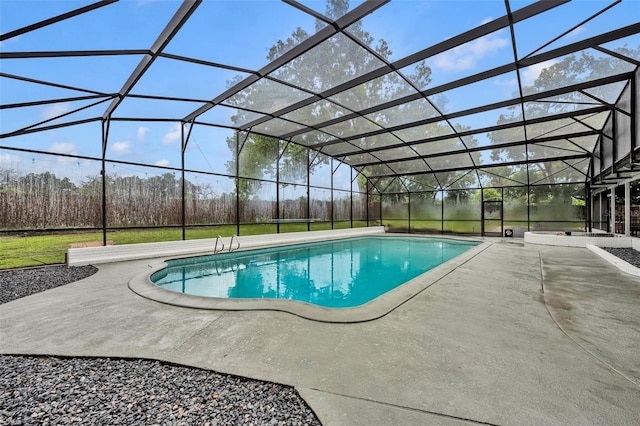 outdoor pool featuring glass enclosure and a patio