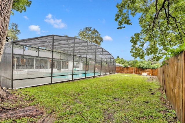 view of yard with a fenced in pool, a lanai, and a fenced backyard