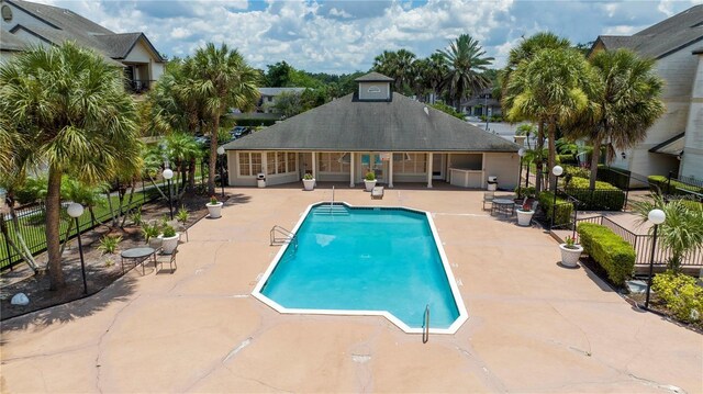 1932 Lake Atriums Cir Unit 86, Orlando, FL 32839 - community pool with a patio area and fence