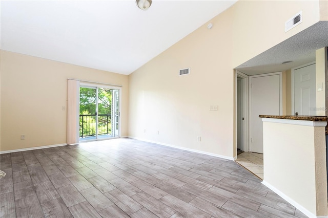 1932 Lake Atriums Cir Unit 86, Orlando, FL 32839 - unfurnished room featuring wood tiled floor, baseboards, high vaulted ceiling, and visible vents