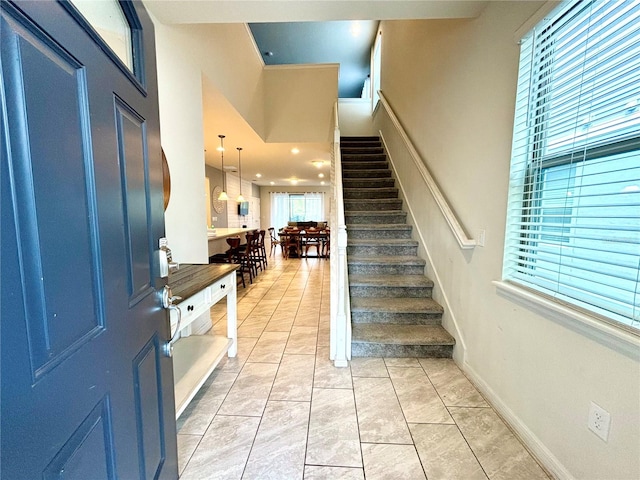 foyer entrance with light tile patterned flooring