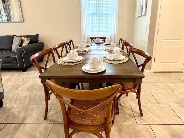 dining space featuring light tile patterned flooring