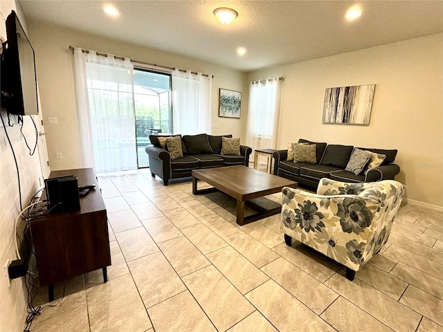 living room with light tile patterned floors and a healthy amount of sunlight