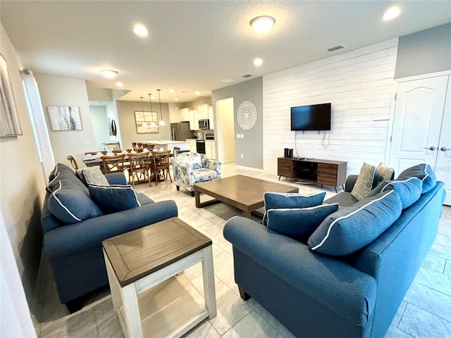 tiled living room featuring wooden walls