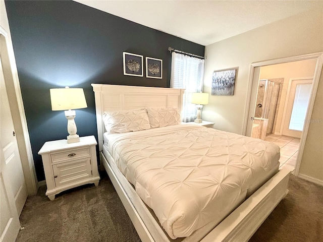 bedroom featuring ensuite bath and carpet floors