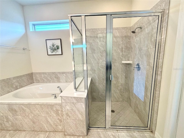 bathroom with independent shower and bath and tile patterned floors