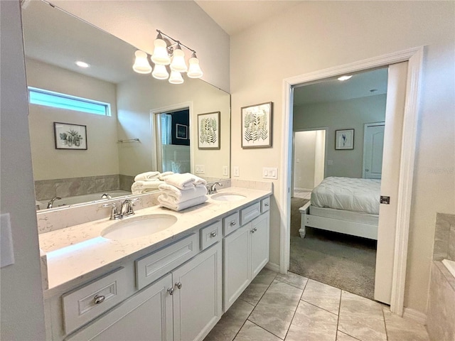 bathroom featuring tiled bath, dual bowl vanity, and tile patterned floors