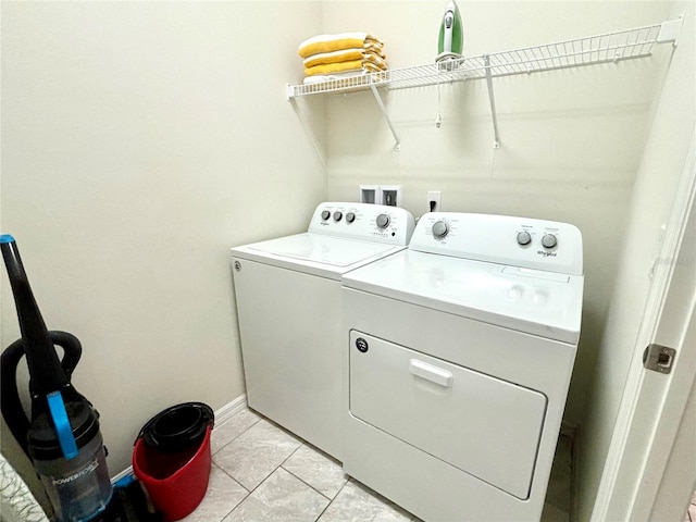 laundry room featuring separate washer and dryer and light tile patterned flooring