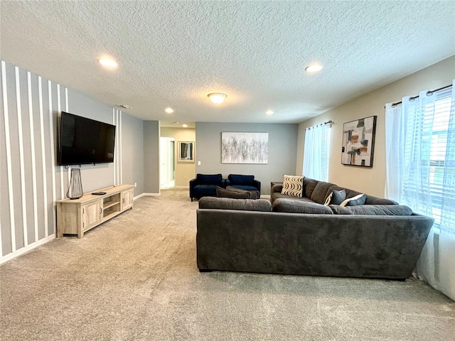 carpeted living room featuring a textured ceiling