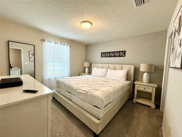 carpeted bedroom featuring a textured ceiling