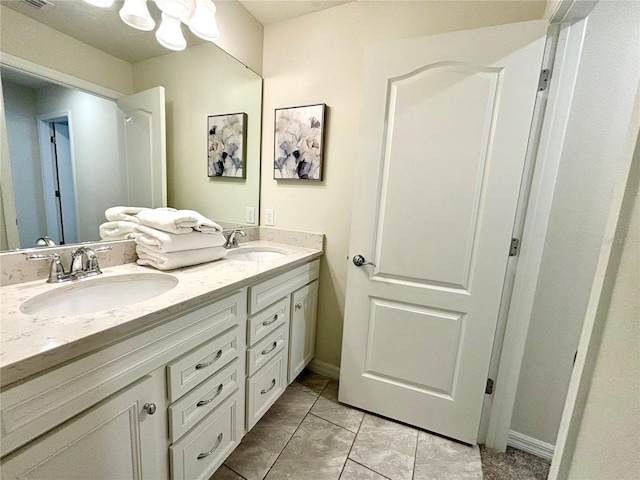 bathroom with dual bowl vanity and tile patterned floors