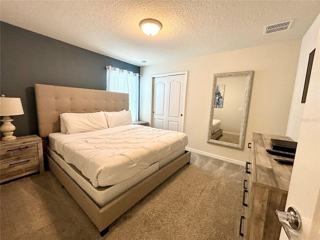 bedroom featuring a textured ceiling, carpet flooring, and a closet