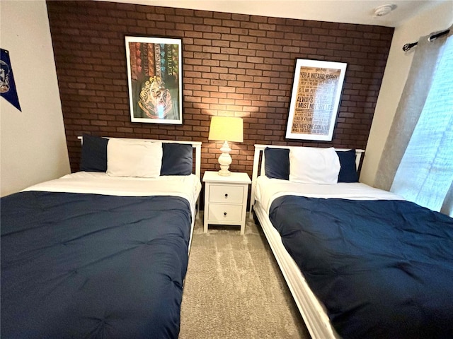 bedroom with brick wall and carpet