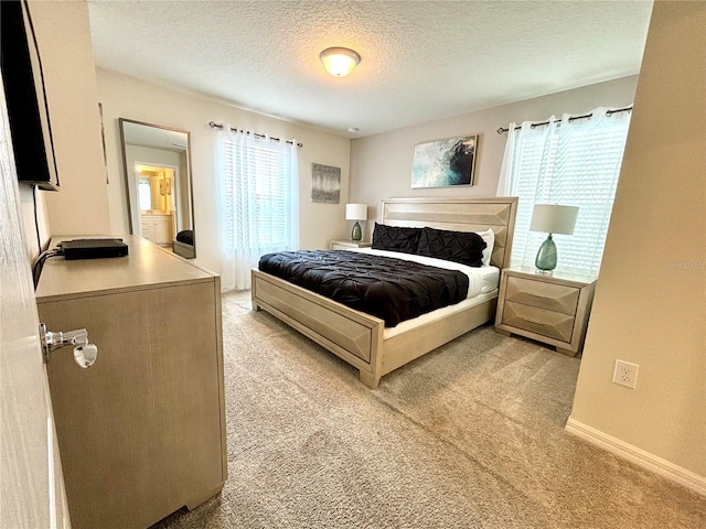 carpeted bedroom featuring a textured ceiling and multiple windows