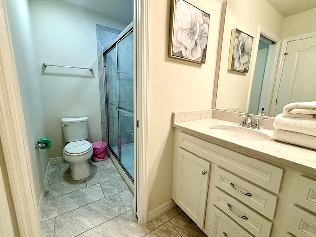 bathroom featuring tile patterned flooring, a shower with door, toilet, and vanity