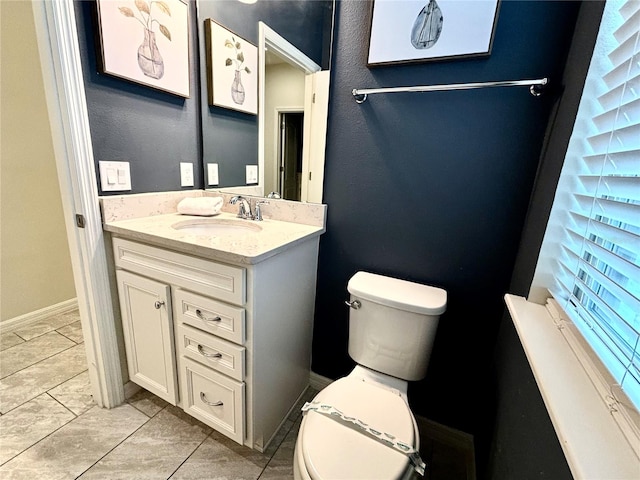 bathroom featuring tile patterned flooring, vanity, and toilet