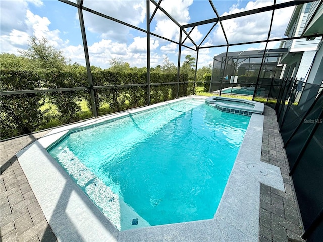 view of swimming pool with an in ground hot tub and a lanai