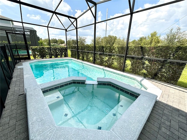 view of swimming pool featuring a lanai and an in ground hot tub