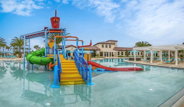 view of play area with a pergola and a community pool