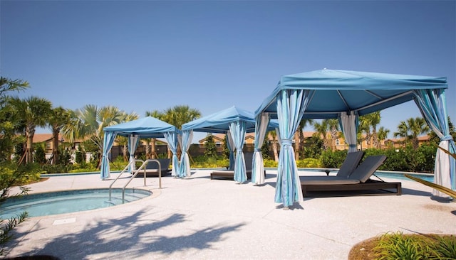 view of swimming pool featuring a gazebo and a patio area