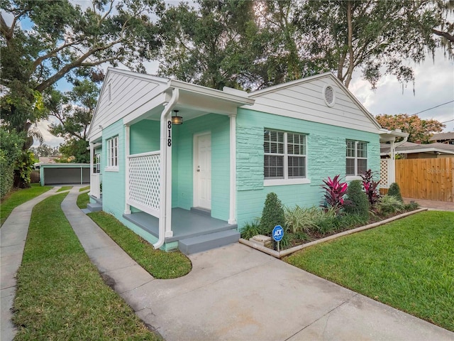 bungalow-style home with a front yard