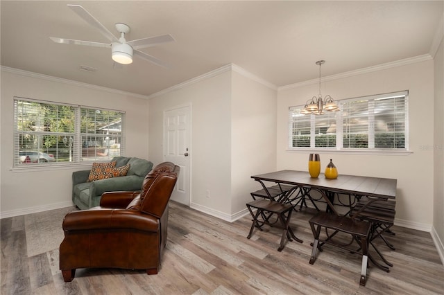 sitting room featuring ceiling fan with notable chandelier, ornamental molding, and hardwood / wood-style flooring