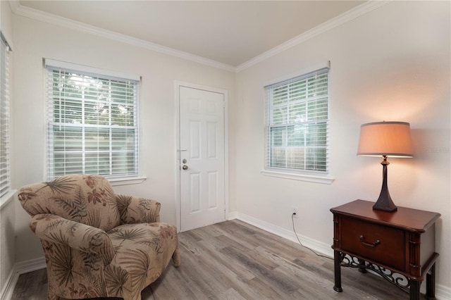 sitting room featuring ornamental molding and hardwood / wood-style flooring