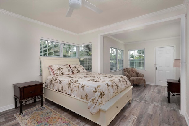 bedroom with ceiling fan, ornamental molding, and wood-type flooring