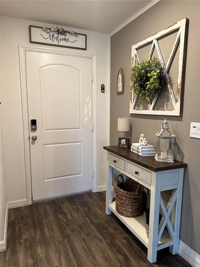 entryway featuring dark wood-style floors and baseboards