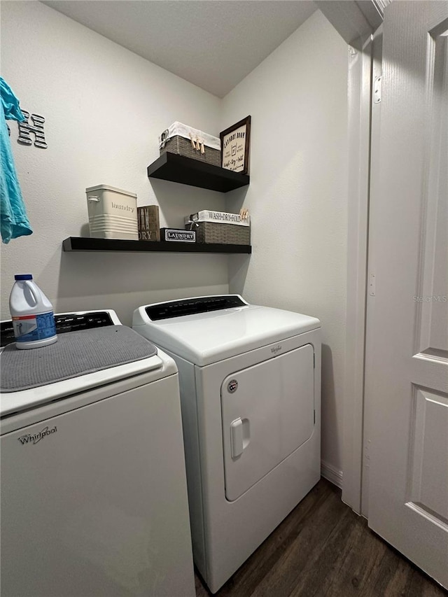 laundry room featuring dark wood-style flooring, laundry area, and washing machine and clothes dryer