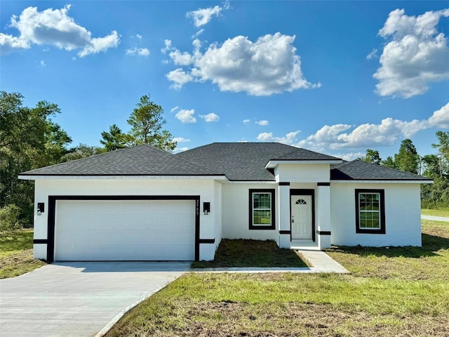 view of front of home with a garage and a front yard