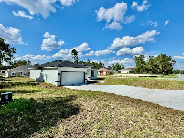 view of side of property with a garage and a yard