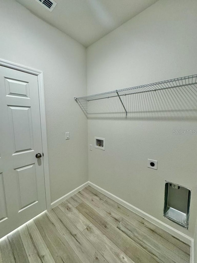 washroom with light wood-type flooring, washer hookup, and electric dryer hookup