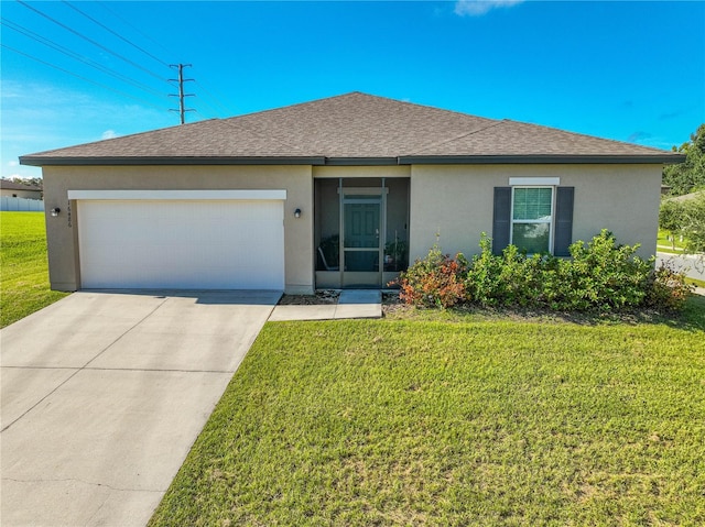 view of front of house with a front yard and a garage